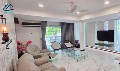 a living room with couches and a flat screen tv at Landed Spacious House at Cangkat Delima Gelugor Penang in Gelugor