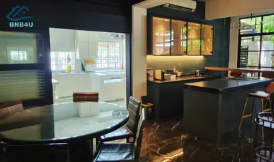 a kitchen with a table and a counter top at Landed Spacious House at Cangkat Delima Gelugor Penang in Gelugor