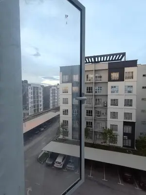 a view of a building from a window at HS homestay Casa Klebang Ipoh in Ipoh