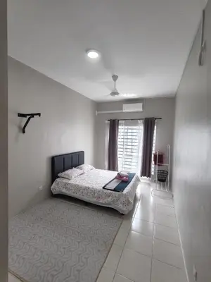 a bedroom with a bed in a white room at HS homestay Casa Klebang Ipoh in Ipoh