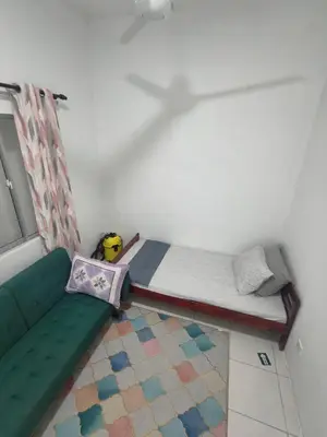 a room with a bed and a couch and a window at HS homestay Casa Klebang Ipoh in Ipoh