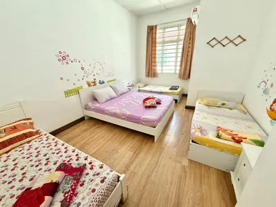 a bedroom with two beds and a couch at 7BR Penang Stay Near Gurney and George Town in Tanjong Tokong