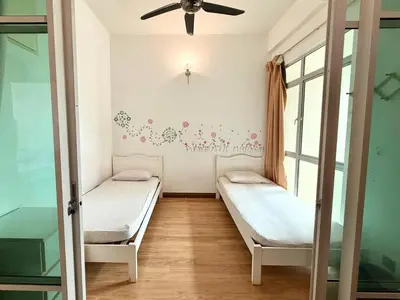 a room with two beds and a ceiling fan at 7BR Penang Stay Near Gurney and George Town in Tanjong Tokong