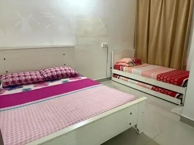 two beds sitting next to each other in a room at 7BR Penang Stay Near Gurney and George Town in Tanjong Tokong