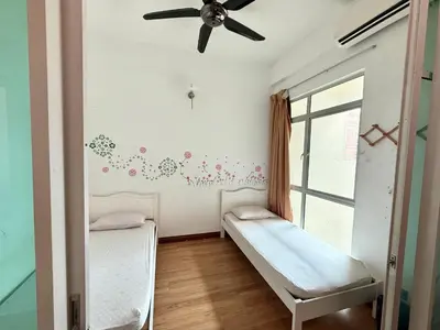 a room with two beds and a ceiling fan at 7BR Penang Stay Near Gurney and George Town in Tanjong Tokong