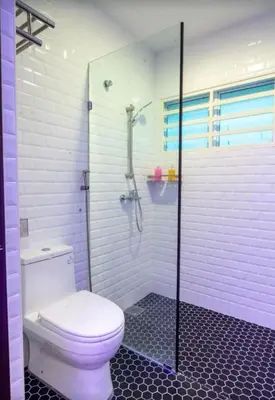 a bathroom with a toilet and a walk in shower at King's Lane in Ipoh