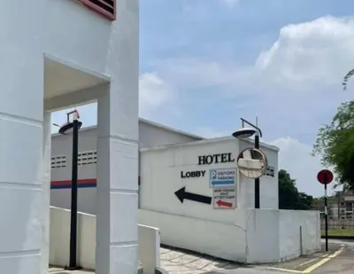 a building with a hotel lease sign in front of it at King's Lane in Ipoh