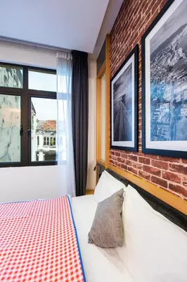 a bedroom with a brick wall and a bed at B Street Hotel in George Town