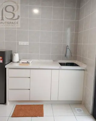 a kitchen with white cabinets and a sink at Putspace Empire-Bandar Baru Putra, Ipoh Perak in Ipoh