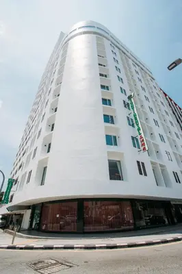 a tall white building with a window at Hotel Continental Penang in George Town