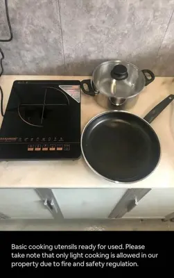 a stove with a pot and a pan on a counter at Bukit Mertajam 1 pax Salesman 5pm to 8am Room in Bukit Mertajam