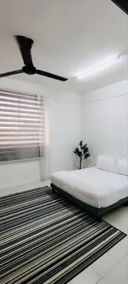 a white bedroom with a bed and a window at HomestayFA in Gua Sai