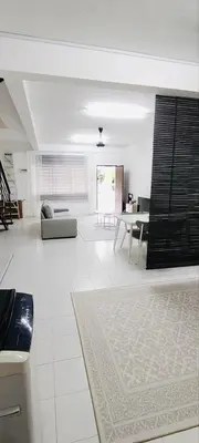 a white living room with a couch and a table at HomestayFA in Gua Sai