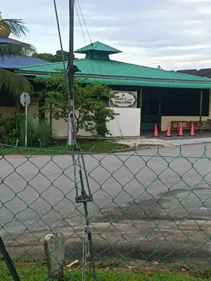 a fence in front of a building with orange cones at HomestayFA in Gua Sai