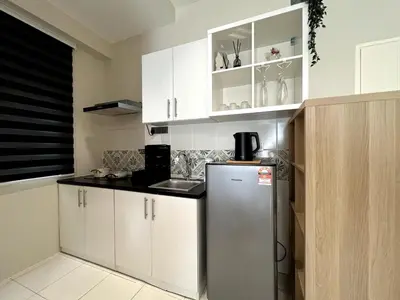 a kitchen with white cabinets and a refrigerator at Relaxstay Anderson Residences, Family Friendly 6px 2br in Ipoh