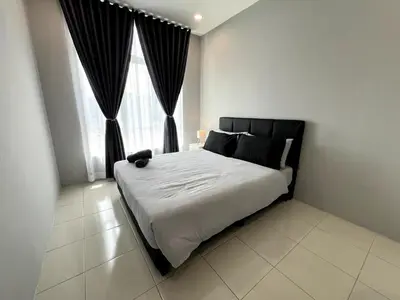 a bedroom with a large bed in front of a window at Relaxstay Anderson Residences, Family Friendly 6px 2br in Ipoh