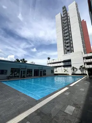 a large swimming pool in front of a building at Relaxstay Anderson Residences, Family Friendly 6px 2br in Ipoh