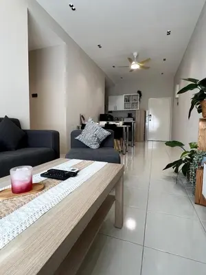 a living room with a couch and a table at Relaxstay Anderson Residences, Family Friendly 6px 2br in Ipoh
