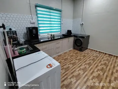 a kitchen with a refrigerator and a wooden floor at Homestay Haji Omar Sungai Dua Butterworth in Kampong Lahar Yooi