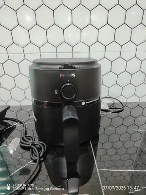 a black appliance sitting on the floor in a kitchen at Homestay Haji Omar Sungai Dua Butterworth in Kampong Lahar Yooi