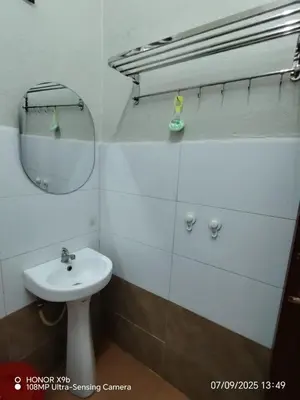 a white bathroom with a sink and a mirror at Homestay Haji Omar Sungai Dua Butterworth in Kampong Lahar Yooi