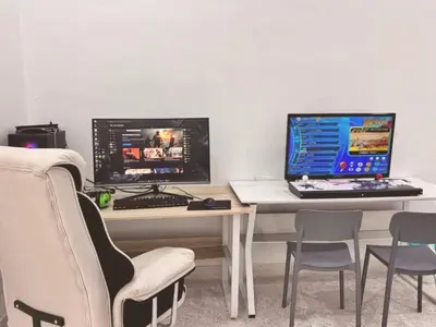 a desk with two monitors and a laptop and chairs at Free EV Car Charge KTV Snooker&PS5Game 13Pax Ipoh in Ipoh