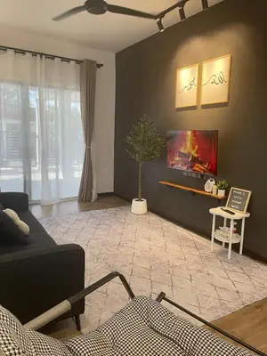 a living room with a couch and a table at Hafiyya Raintown Homestay, Taiping in Taiping
