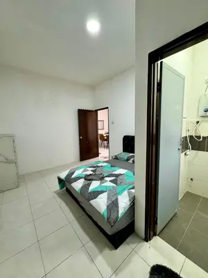 a bedroom with a bed and a door to a bathroom at AYAAN Gamer's Pitstop at Tanah Rata Cameron Highland in Tanah Rata