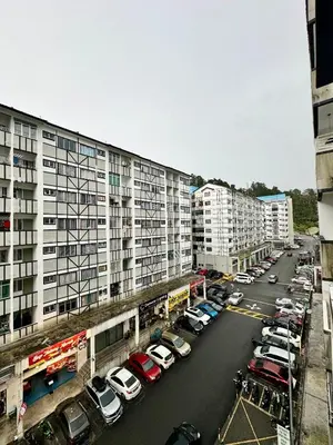 a parking lot with cars parked in front of buildings at AYAAN Gamer's Pitstop at Tanah Rata Cameron Highland in Tanah Rata