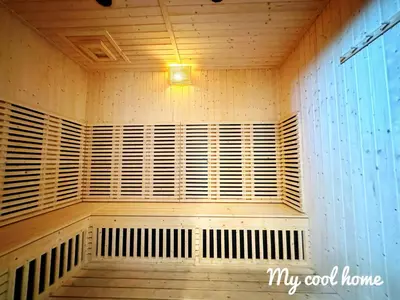 a room with wooden shuttered windows and a light at Onsen Suite Theme Park View in Ipoh