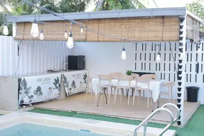 a patio with a table and chairs next to a pool at Sarang A Cottage with private pool in Sungai Petani