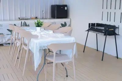 a white table with chairs and a piano in a room at Sarang A Cottage with private pool in Sungai Petani