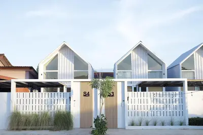 a house with white gates and a white fence at Sarang A Cottage with private pool in Sungai Petani