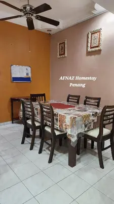 a dining room with a table and chairs at Afnaz Homestay Penang in Perai