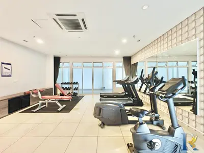 a gym with treadmills and cardio equipment in a building at Austin Manhattan by RR JBcity in Gua Sai