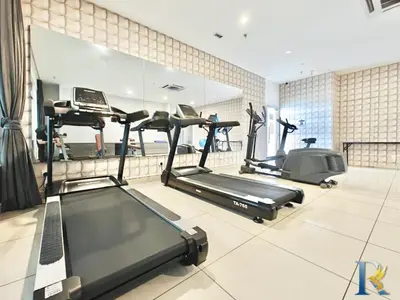 a gym with three treadmills and a mirror at Austin Manhattan by RR JBcity in Gua Sai