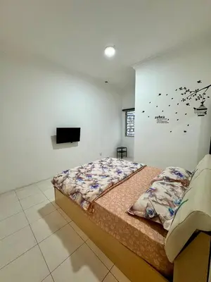 a bedroom with a bed and a flat screen tv at AYAAN Highland Escape with PS4 gaming and Netflix at Cameron Highland in Tanah Rata