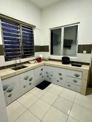 a kitchen with white cabinets and a sink and a window at AYAAN Highland Escape with PS4 gaming and Netflix at Cameron Highland in Tanah Rata