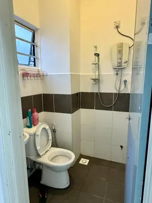 a bathroom with a toilet and a shower at AYAAN Highland Escape with PS4 gaming and Netflix at Cameron Highland in Tanah Rata