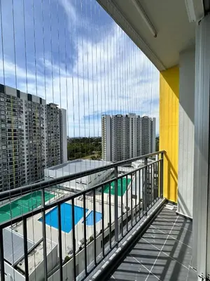 a balcony with a view of a pool and buildings at Residensi Seri Serindit Melaka in Gua Sai