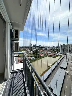 a balcony with a large window with a view of a city at Residensi Seri Serindit Melaka in Gua Sai