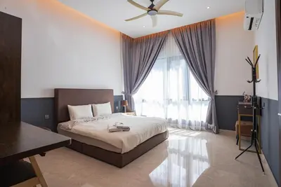 a bedroom with a bed with a ceiling fan and a window at Cheekaaboo Playhouse Ipoh I Private Pool Family Stay with Indoor Playzone in Ipoh