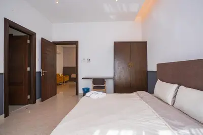 a bedroom with a large bed and a desk at Cheekaaboo Playhouse Ipoh I Private Pool Family Stay with Indoor Playzone in Ipoh