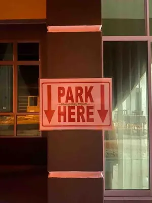 a sign that says i park here on a building at Hijrah De La Villa Parit Buntar Nibong Tebal Penang in Nibung Tebal