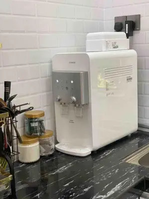 a white coffee maker sitting on top of a counter at Hijrah De La Villa Parit Buntar Nibong Tebal Penang in Nibung Tebal