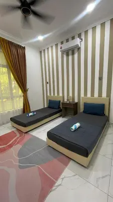 two beds in a bedroom with a ceiling at Hijrah De La Villa Parit Buntar Nibong Tebal Penang in Nibung Tebal