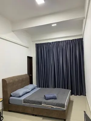 a bedroom with a bed and a window with curtains at Mekla Hotel Studio Apartment in Gua Musang