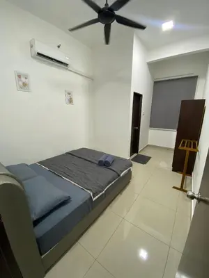 a bedroom with a bed and a ceiling fan at Mekla Hotel Studio Apartment in Gua Musang