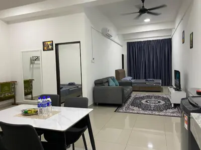 a living room with a table and a couch at Mekla Hotel Studio Apartment in Gua Musang