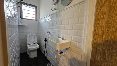 a bathroom with a sink and a toilet at Batu Puteh Chalet by the River, Pool, WIFI